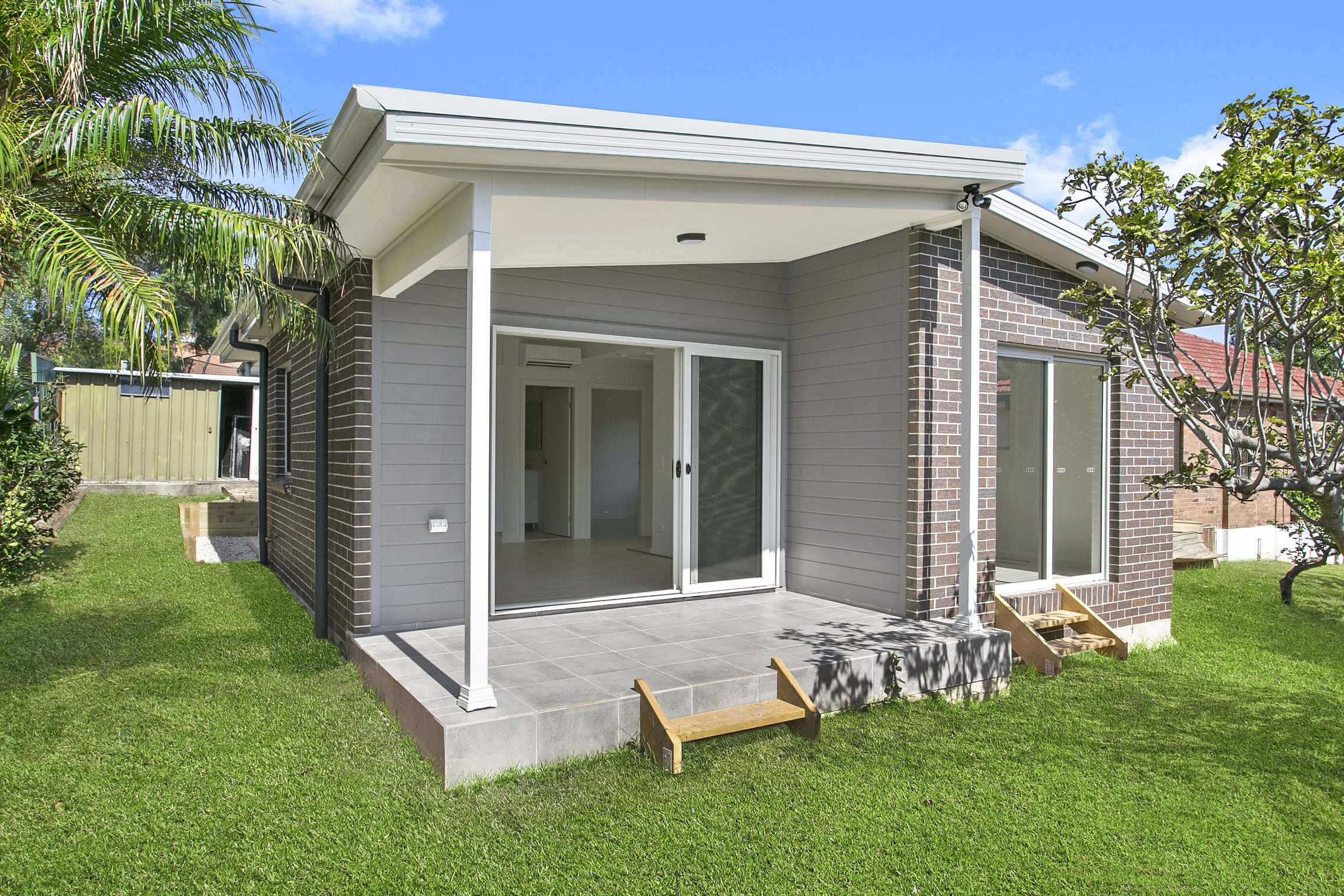 Granny flat with small covered patio and two sliding door points of entry