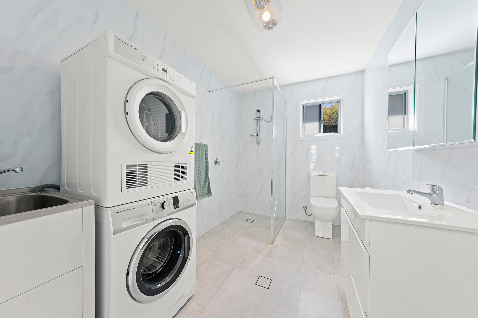 bathroom with washer and dryer in it